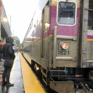 subway commuter standing next to train