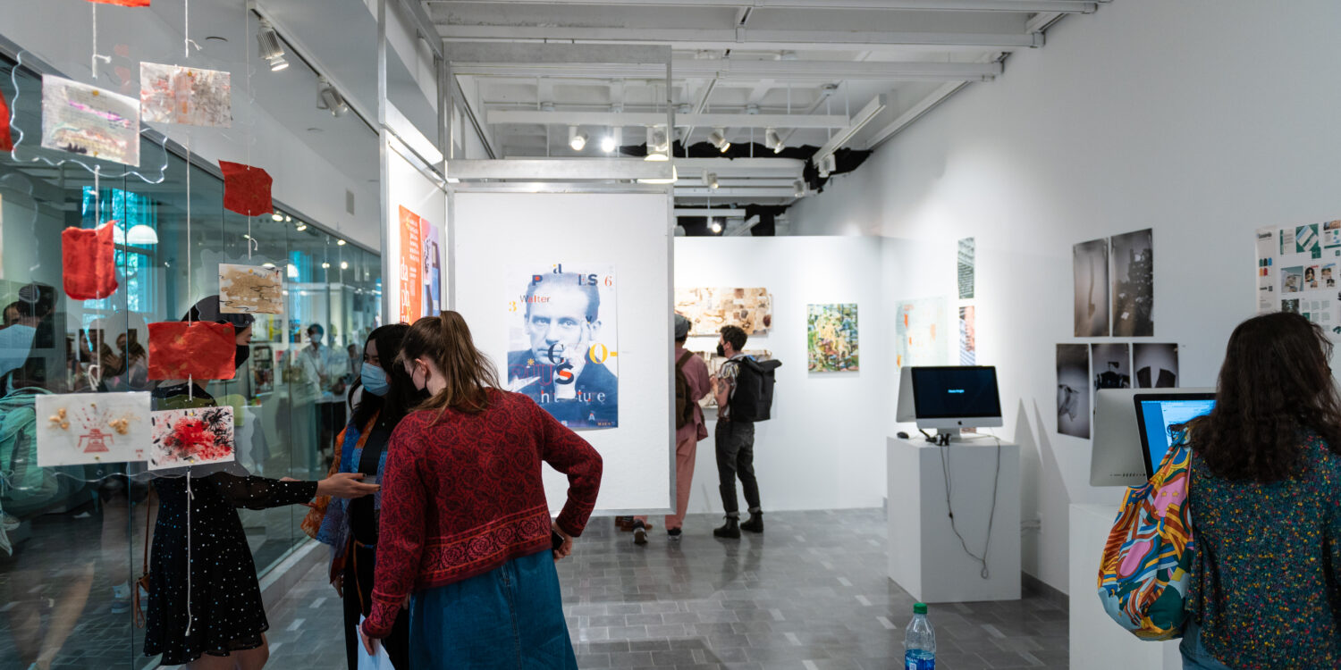 Image shows people gathered in Gallery360 for the Art + Design Senior Show.