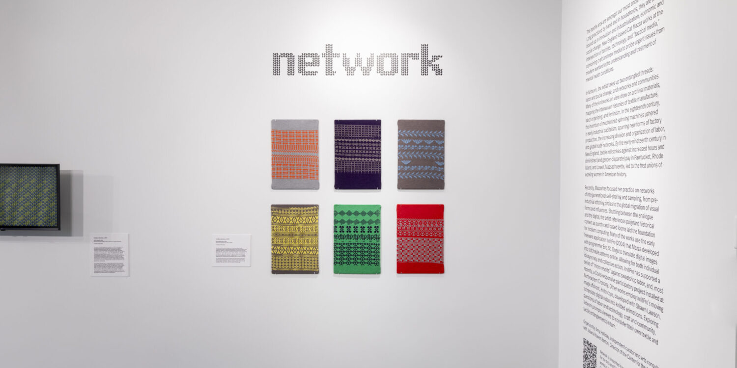 The image features a wall display of various abstract textile artworks by Cat Mazza. The central text on the wall reads "network," referring to the exhibition's themes around connectivity and technology. The artworks displayed are a series of rectangular panels, each featuring a distinct pattern or design in a variety of colors and styles, including geometric shapes, lines, and textures. The patterns were created with artist Cat Mazza's free web program, "Knitpro."